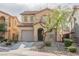 Charming two-story home featuring desert landscaping, a tile roof, and an attached garage at 1161 Gecko Rd, Henderson, NV 89002