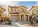 Charming two-story home featuring desert landscaping, a tile roof, and an attached garage at 1161 Gecko Rd, Henderson, NV 89002