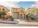 Charming two-story home featuring desert landscaping, a tile roof, and an attached garage at 1161 Gecko Rd, Henderson, NV 89002