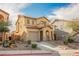 Charming two-story home featuring desert landscaping, a tile roof, and an attached garage at 1161 Gecko Rd, Henderson, NV 89002