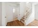 Hallway with staircase and a door leading to a half-bath with a tiled floor at 1161 Gecko Rd, Henderson, NV 89002