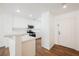 Bright kitchen features white cabinets, stainless steel appliances, and breakfast bar at 1161 Gecko Rd, Henderson, NV 89002