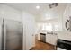 Well-lit kitchen with stainless steel appliances, white cabinets, and wood-look floors at 1161 Gecko Rd, Henderson, NV 89002