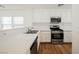 Kitchen with white counters and cabinets plus stainless steel appliances and wood look floors at 1161 Gecko Rd, Henderson, NV 89002