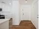 Bright kitchen features white cabinets, stainless steel appliances, and wood-look floors at 1161 Gecko Rd, Henderson, NV 89002