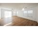 Spacious living room featuring wood-look floors, ceiling fan, and ample natural light at 1161 Gecko Rd, Henderson, NV 89002