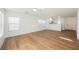 Bright open concept living room with wood-look floors and an open design to the kitchen at 1161 Gecko Rd, Henderson, NV 89002