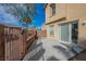 Concrete patio with sliding glass door access to the house and block wall separating the yard at 1161 Gecko Rd, Henderson, NV 89002