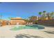 A community pool with palm trees in the background on a sunny day at 1161 Gecko Rd, Henderson, NV 89002