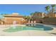 Community pool surrounded by lush landscaping and well-maintained townhomes under a clear blue sky at 1161 Gecko Rd, Henderson, NV 89002