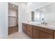 Double vanity bathroom with a large mirror and walk-in closet at 8965 Coastal Oaks St, Las Vegas, NV 89166