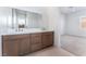 Double vanity bathroom with marble countertops and large mirror at 8965 Coastal Oaks St, Las Vegas, NV 89166