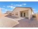 Tan house with covered patio and grassy backyard at 8965 Coastal Oaks St, Las Vegas, NV 89166