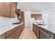 Modern kitchen with wood cabinets, white backsplash, and stainless steel appliances at 8965 Coastal Oaks St, Las Vegas, NV 89166