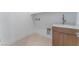 Bright laundry room with modern cabinetry and a utility sink at 8965 Coastal Oaks St, Las Vegas, NV 89166