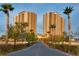 Luxury condo building with palm trees and paved driveway at 8255 S Las Vegas Blvd # 1521, Las Vegas, NV 89123