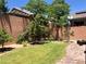 Private backyard featuring lush green grass, brick pavers and desert landscaping at 7421 Old Compton St, Las Vegas, NV 89166