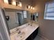 Bathroom featuring a double sink vanity with a large mirror and modern fixtures, plus access to another bathroom at 7421 Old Compton St, Las Vegas, NV 89166