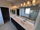 Bright bathroom with a double sink vanity, a soaking tub, and a glass-enclosed shower at 7421 Old Compton St, Las Vegas, NV 89166