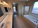 Bright bathroom features a dual sink vanity, soaking tub, and a glass-enclosed shower for a spa-like experience at 7421 Old Compton St, Las Vegas, NV 89166