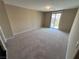 Spacious bedroom with carpet flooring and a sliding glass door to a balcony at 7421 Old Compton St, Las Vegas, NV 89166