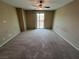 Large bedroom with a ceiling fan, sliding doors, and neutral carpet, creating a cozy retreat at 7421 Old Compton St, Las Vegas, NV 89166