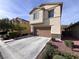 Two-story stucco home with a two-car garage and well-maintained landscaping at 7421 Old Compton St, Las Vegas, NV 89166