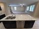 Open kitchen island with stainless steel dishwasher overlooking living space and stairs at 7421 Old Compton St, Las Vegas, NV 89166