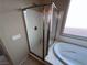 A modern glass-enclosed shower and soaking tub at 7421 Old Compton St, Las Vegas, NV 89166