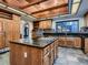 Traditional kitchen with a kitchen island, tile backsplash, granite countertops, and wood ceiling at 1 Quail Run Rd, Henderson, NV 89014