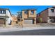 Tan two-story house with gray garage door, front walkway and landscaping at 106 Via Franello, Henderson, NV 89011