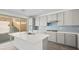 Modern kitchen with island, gray cabinets, stainless steel appliances and access to backyard at 106 Via Franello, Henderson, NV 89011