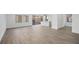 Open living room and kitchen area with wood-like tile floors at 106 Via Franello, Henderson, NV 89011