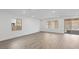 Bright and spacious living room with wood-look tile flooring and sliding glass doors at 106 Via Franello, Henderson, NV 89011