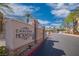 Chateau Nouveau community entrance sign next to a paved street, complemented by palm trees and a clear blue sky at 10001 Peace Way # 2322, Las Vegas, NV 89147