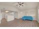 Cozy living room featuring vaulted ceilings, a stylish blue sofa, and wood-look floors for a modern touch at 10001 Peace Way # 2322, Las Vegas, NV 89147