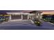 Contemporary home featuring an attached two-car garage, desert landscaping, and city views at 616 Scenic Rim Dr, Henderson, NV 89012