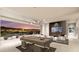 Open concept living space with a pool table, modern fireplace, and stunning city views at 616 Scenic Rim Dr, Henderson, NV 89012