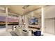 Modern living area featuring a fireplace, television, bar seating, and an incredible view of the city skyline at 616 Scenic Rim Dr, Henderson, NV 89012