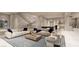 Spacious living area with plush seating, modern staircase, and stylish décor at 616 Scenic Rim Dr, Henderson, NV 89012