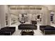 Spacious living area featuring modern sofas, sleek black accents, and an open layout flowing into the dining and kitchen spaces at 616 Scenic Rim Dr, Henderson, NV 89012