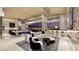 Expansive living room with floor-to-ceiling windows, modern furnishings, a sleek bar, and stunning city views at 616 Scenic Rim Dr, Henderson, NV 89012