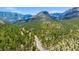 Aerial view of a winding road through a lush forest, leading to serene mountain landscapes at 4205 Mont Blanc Way, Las Vegas, NV 89124