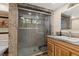 Modern bathroom featuring a glass shower and a granite countertop with sink at 4205 Mont Blanc Way, Las Vegas, NV 89124