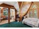 Unique A-frame bedroom featuring wood ceilings, a balcony, and natural light at 4205 Mont Blanc Way, Las Vegas, NV 89124