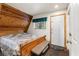 Cozy bedroom with wood-paneled accent wall, queen size bed, bench and natural light at 4205 Mont Blanc Way, Las Vegas, NV 89124