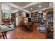 Large dining room with hardwood floors, a large built-in bookshelf, and plenty of seating at 4205 Mont Blanc Way, Las Vegas, NV 89124