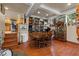 Hardwood floors and natural light fill this dining room with bookshelves and access to the kitchen at 4205 Mont Blanc Way, Las Vegas, NV 89124