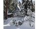 A-frame cabin nestled among snow-covered trees, offering a serene winter retreat with unique architectural charm at 4205 Mont Blanc Way, Las Vegas, NV 89124