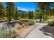 Picturesque walking path meanders past lush foliage, with a charming bridge and mountain views at 4205 Mont Blanc Way, Las Vegas, NV 89124